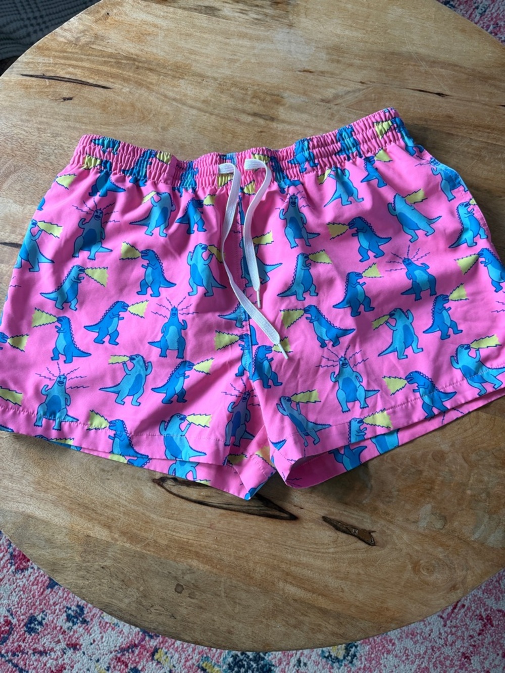 chubbies Pink Swim Shorts with Blue Dinosaur Print and Yellow Accents